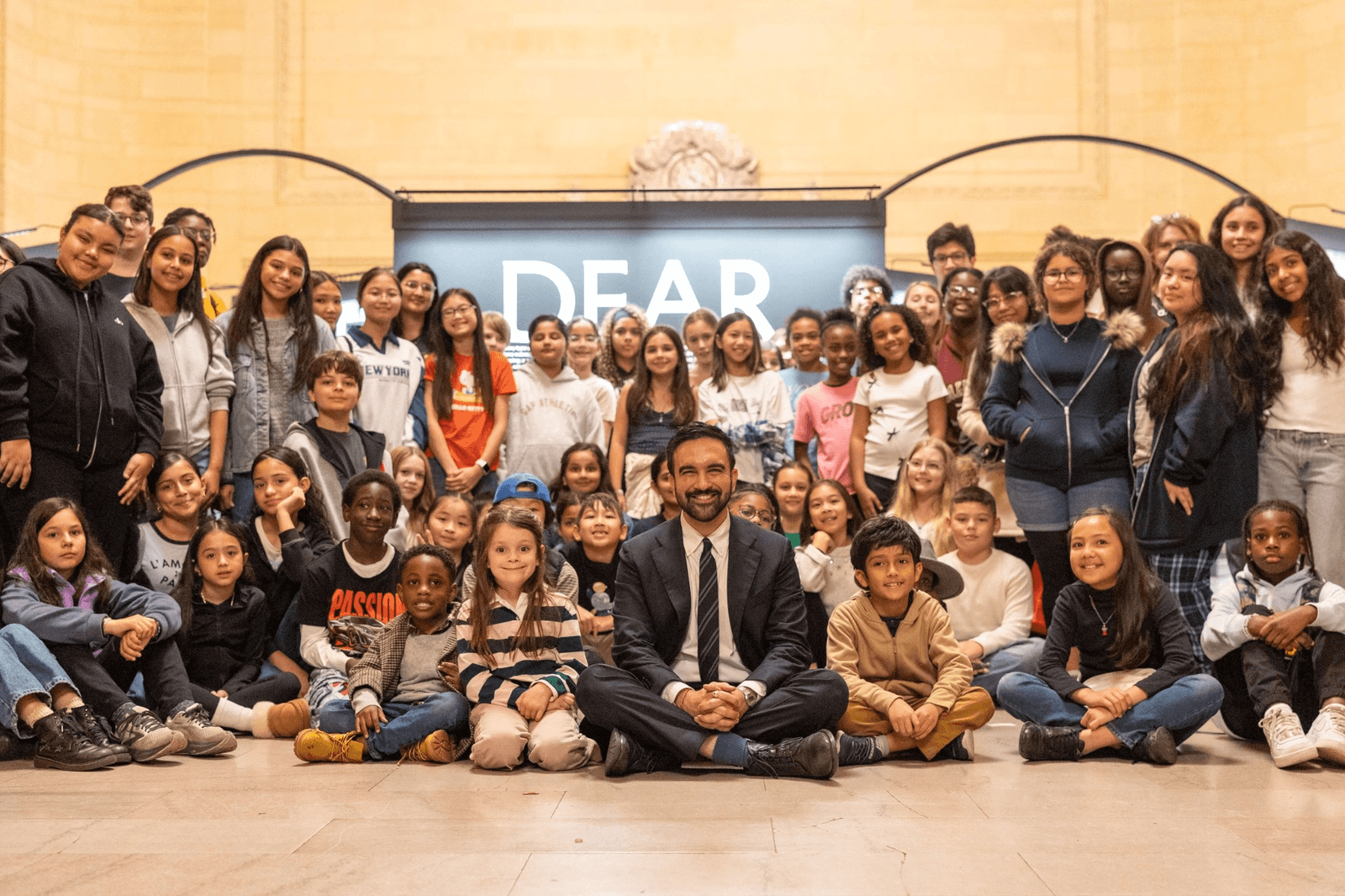 Zohran Mamdani surrounded by some of the student artists.